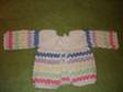 This beautiful sweater is for a newborn. It is made from